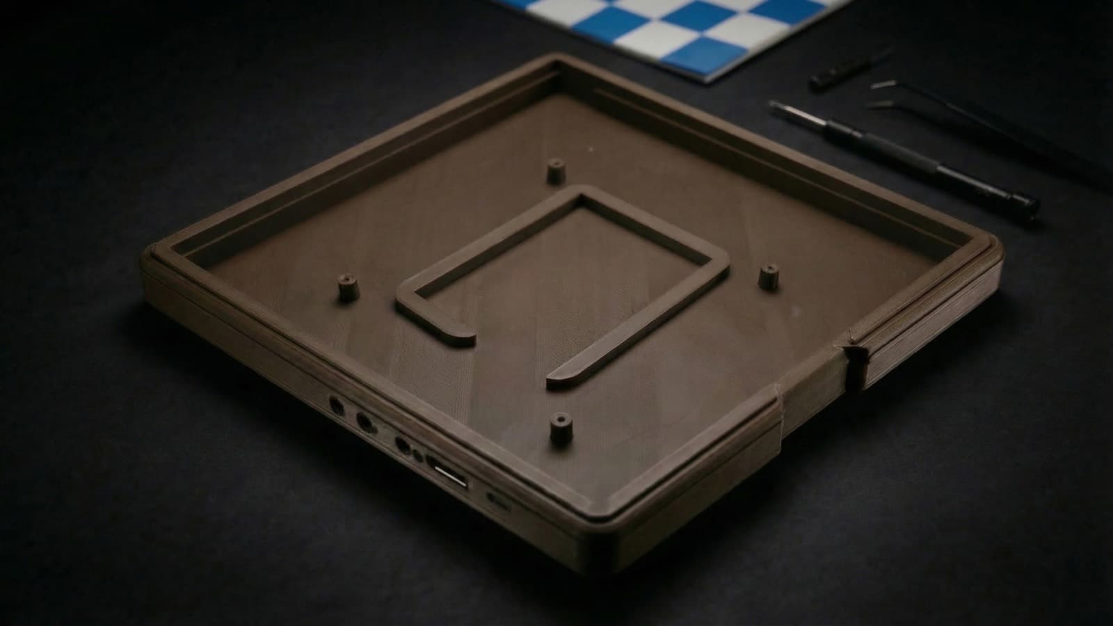 An empty 3D-printed Open Chess enclosure with the USB-C and button cutouts visible.